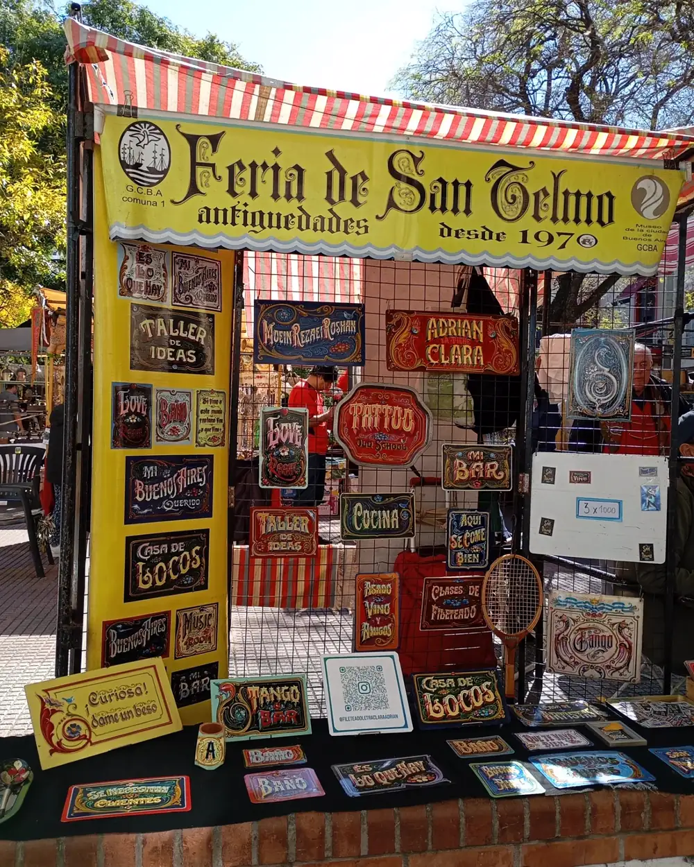 A stall of hand-painted fileteado signs at the Feria de San Telmo